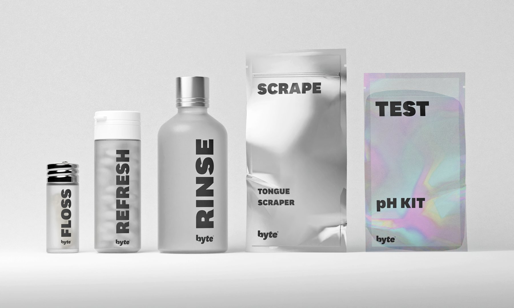 Flat lay of byte foil packs, rinse bottles, and tongue scraper on white